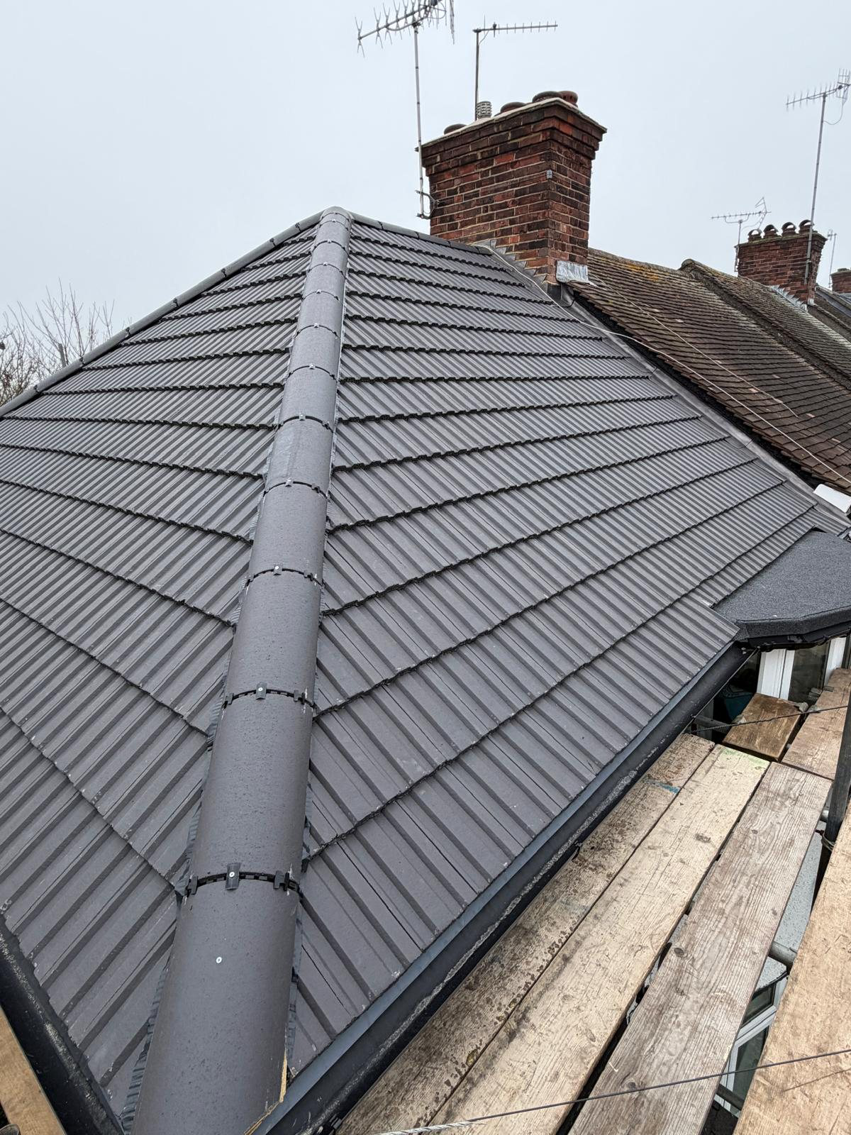 Jakeman Roofing completed new tiled roof project with dark black tiles in Ruislip.