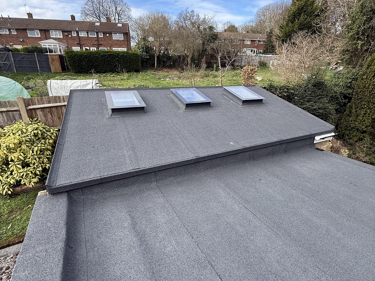 Completed refelted felt flat roof showing 3 skylights and stepped level flat roof in Ruislip Middlesex works carried out by Jakeman Roofing Ltd.