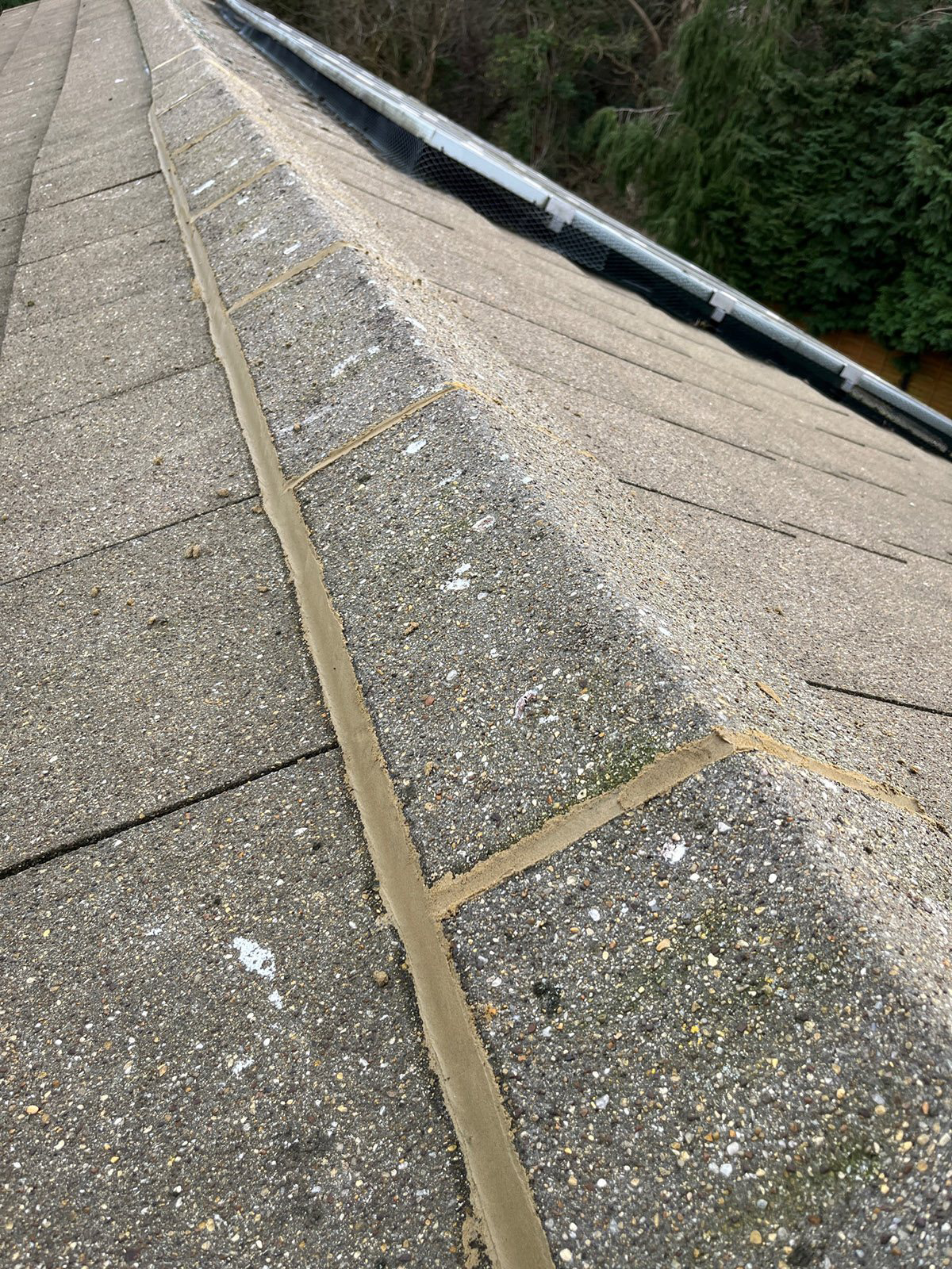 Roof ridge detail works in light grey ridge tiles by Jakeman Roofing Ltd.