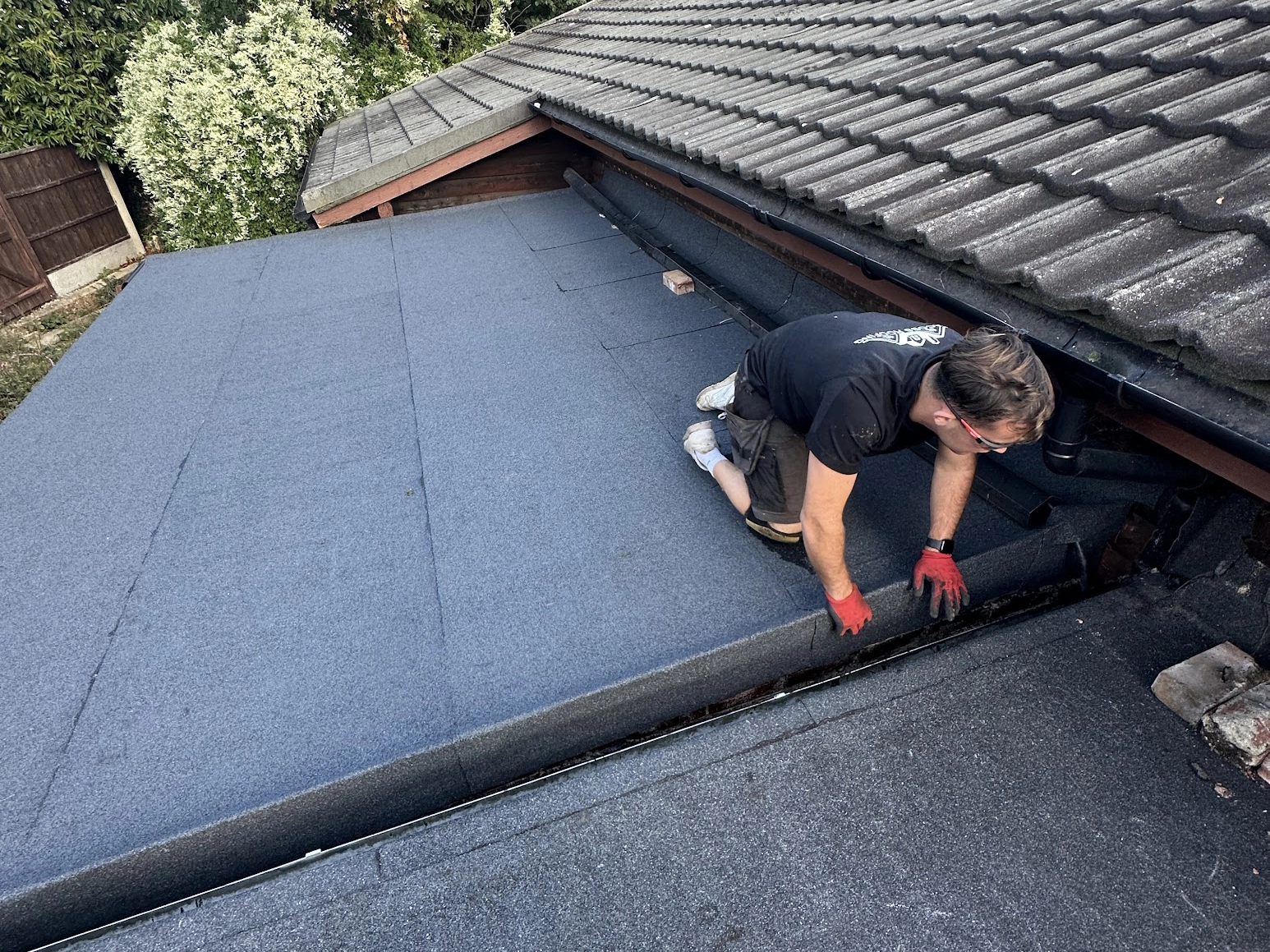 Image of roofer on roof carrying out repairs by Jakeman Roofing Ltd.
